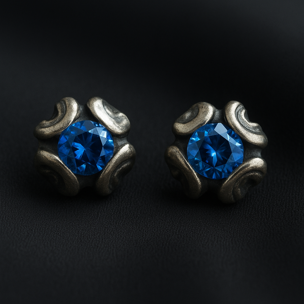 Pair of silver earrings with blue gemstones on a black background