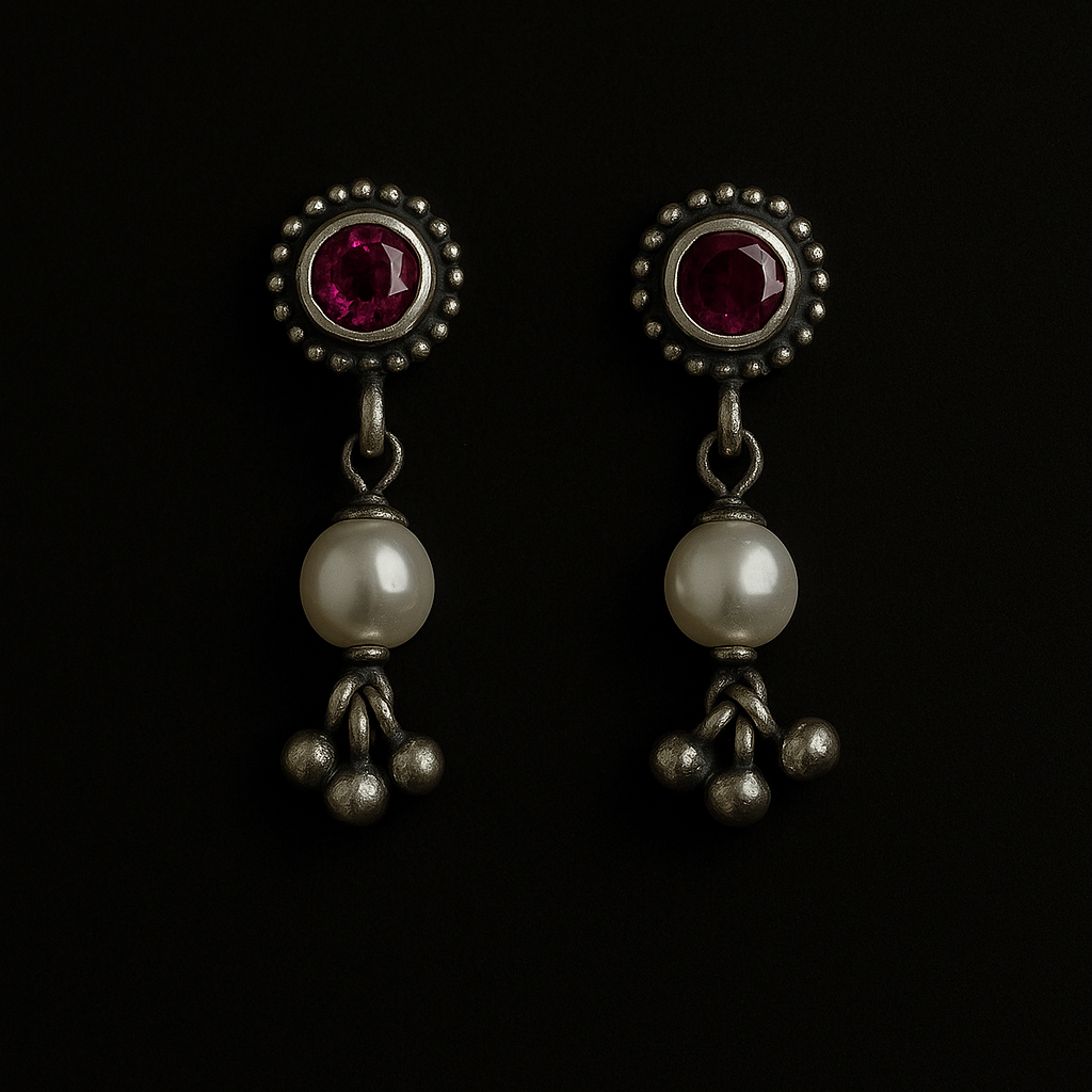 Pair of earrings with gemstones and pearls on a black background
