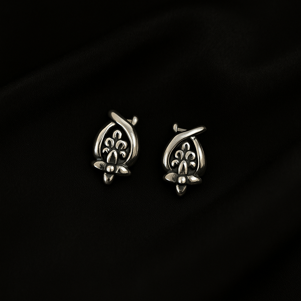 Pair of silver earrings on a dark background